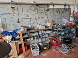 many tools and tools on the workbench in this garage
