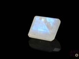 a close up of a square white stone with a blue light on it