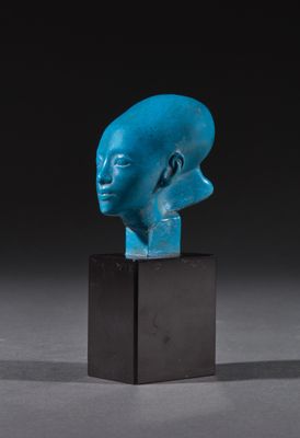une sculpture bleue représentant une tête d'homme, posée sur un socle noir