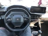 someone is sitting in the driver ' s seat of a car with their feet on the steering wheel