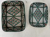 three decorative trays sitting on top of a white surface