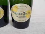 two bottles of champagne sitting next to each other on a table