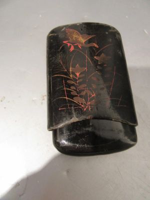 a black case with red flowers on it on a table