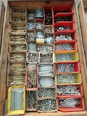 many different types of screws and nuts in a box