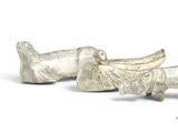 two silver figurines of birds on a white surface