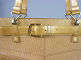 a tan purse with a metal buckle on it