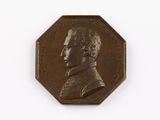 une image représentant un médaillon en bronze à l'effigie d'un homme