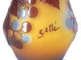 a yellow vase with a brown and blue design on it