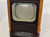 a small television sitting on top of a white table