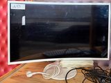 a computer monitor sitting on top of a wooden desk