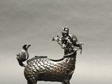 statue of a goat with a bird perched on its back