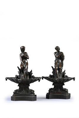 pair of bronze figurines of a boy and a girl on a lotus flower