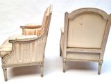 two chairs that are next to each other on a white surface
