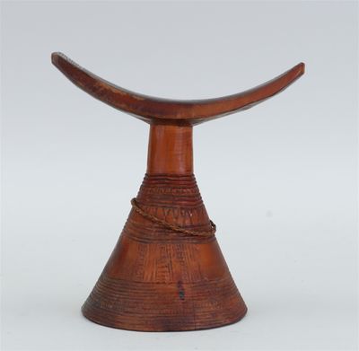 an image of a wooden stool with a curved top