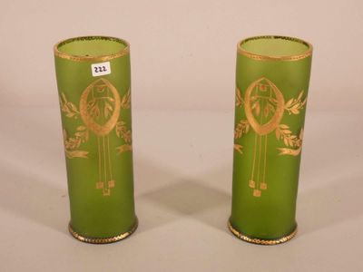 pair of green vases with gold designs on them sitting on a white surface