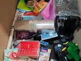 a cardboard box filled with various items and supplies