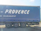 a large blue truck that is parked in a lot