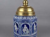 an image of a blue and white vase with a gold lid