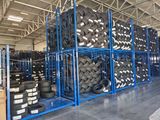 a lot of tires stacked on a rack in a warehouse