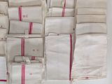 a lot of bags that have red stripes on them