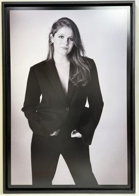 black and white photograph of a woman in a suit posing for a picture