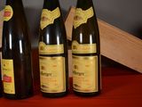 several bottles of wine are lined up on a red table