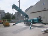 a crane that is sitting on the ground in front of a building