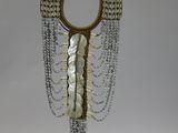 an image of a necklace made of shells and chains