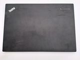 a black laptop sitting on a white surface
