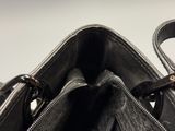 the inside of a black purse with two zippers on it