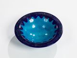 a blue bowl sitting on top of a white table