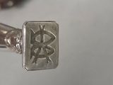 a silver ring with a chinese writing on it