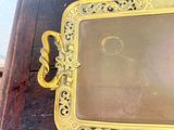 a picture of a gold picture frame on a wooden table