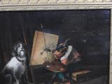 a painting of a dog sitting next to a painting easel