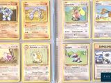 several pokemon cards are displayed on a table in a display case