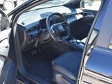 the interior of a car with the door open and the driver ' s seat down