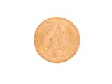 a gold coin on a white surface with a white background