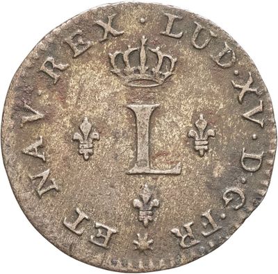 une pièce d'argent surmontée d'une couronne