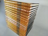 many books stacked on top of each other on a table