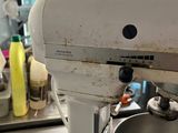 a mixer that is sitting on the counter in the kitchen