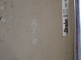 a sticker on the wall of a bathroom that is dirty