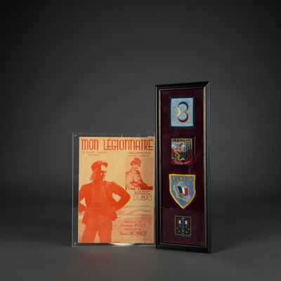two framed medals and a plaque with a picture of a man