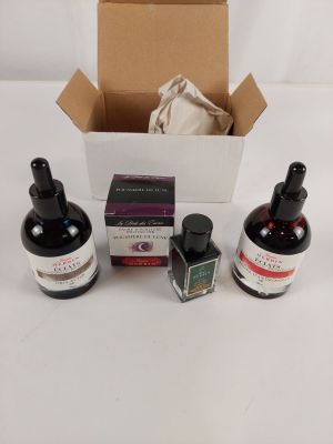 three bottles of ink sitting next to each other on a table