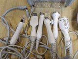 a lot of hair dryers that are sitting on a table