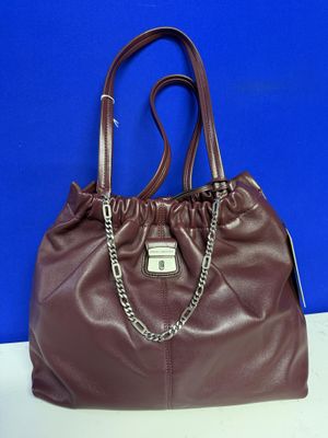 a brown purse with a chain on the handle
