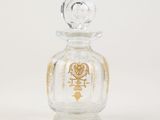 an image of a glass bottle with a gold design on it
