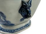 a blue and white bowl with a horse head on it