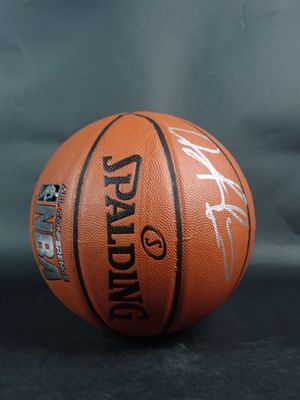 a close up of a basketball on a table with a black background