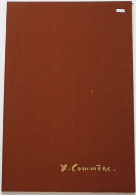 un livre rouge orné d'inscriptions dorées, posé sur une table blanche