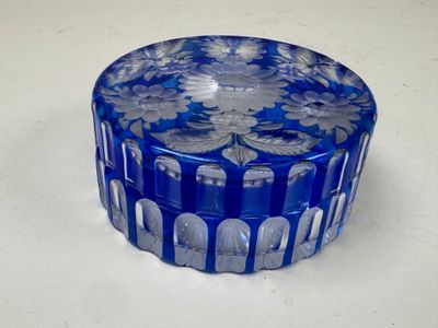 an image of a blue glass container with flowers on it